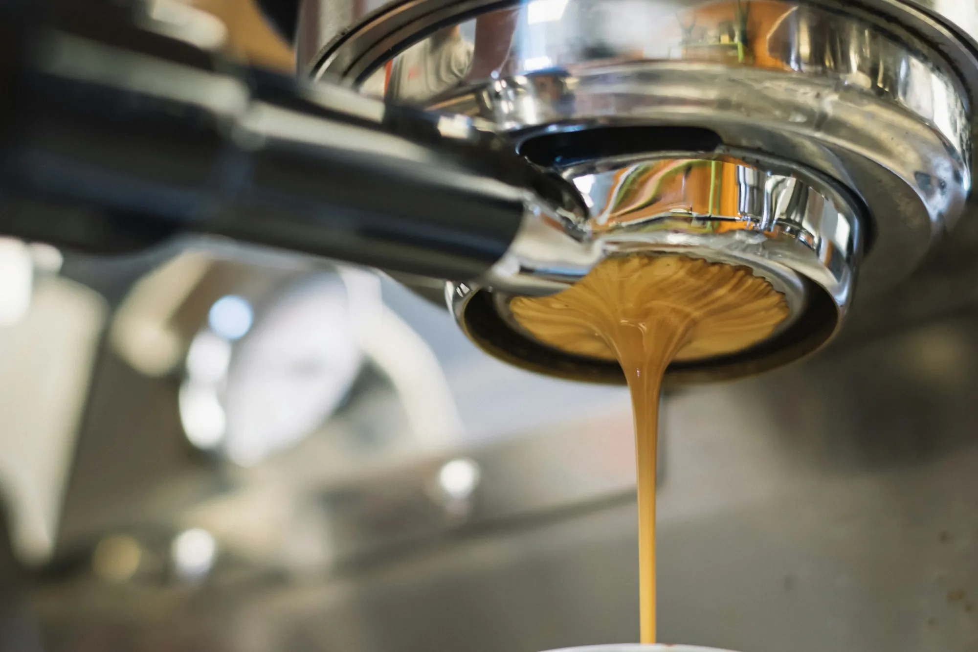 Espresso pouring from a commercial coffee machine