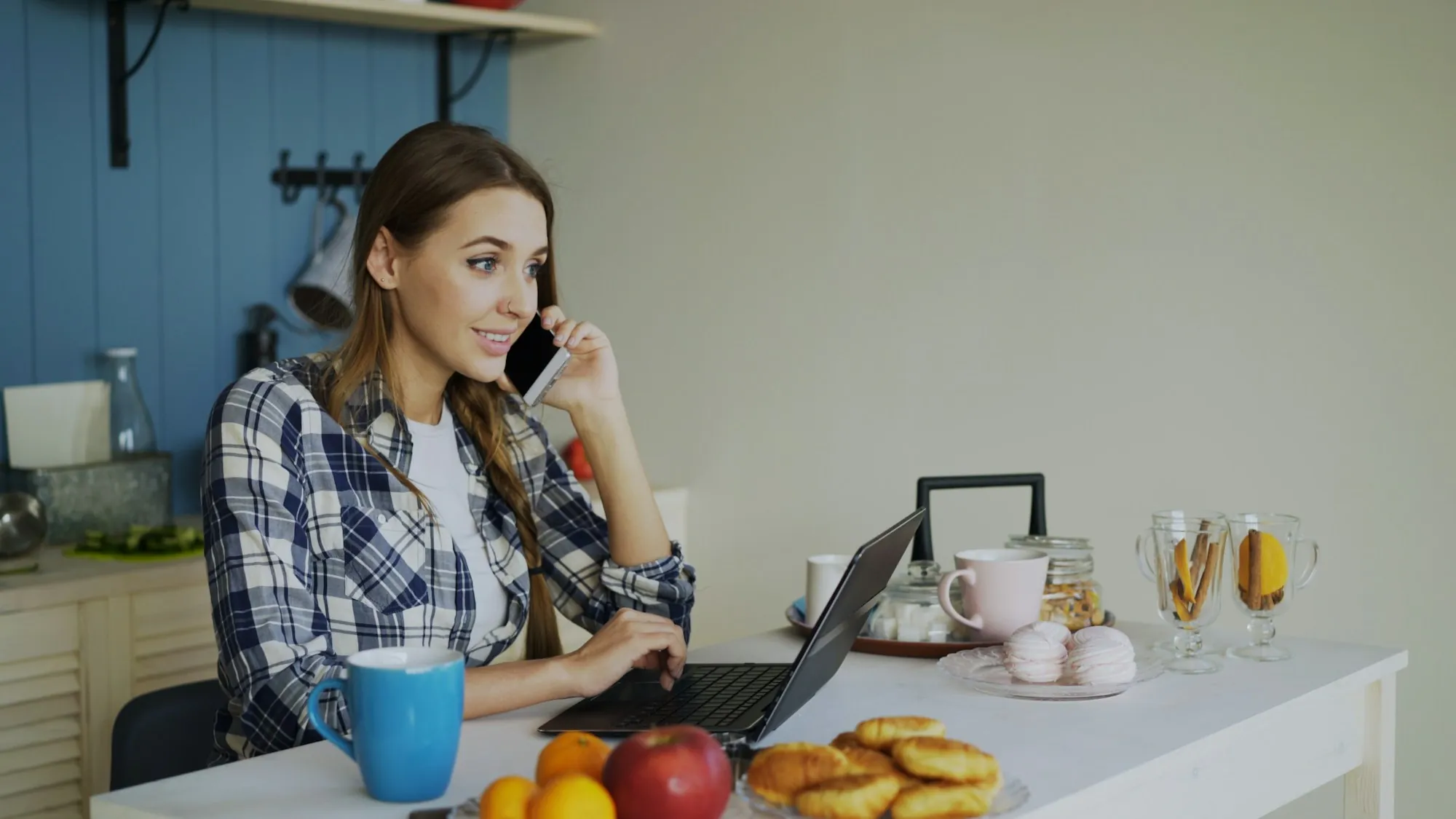 Woman on the phone at her kitchen table