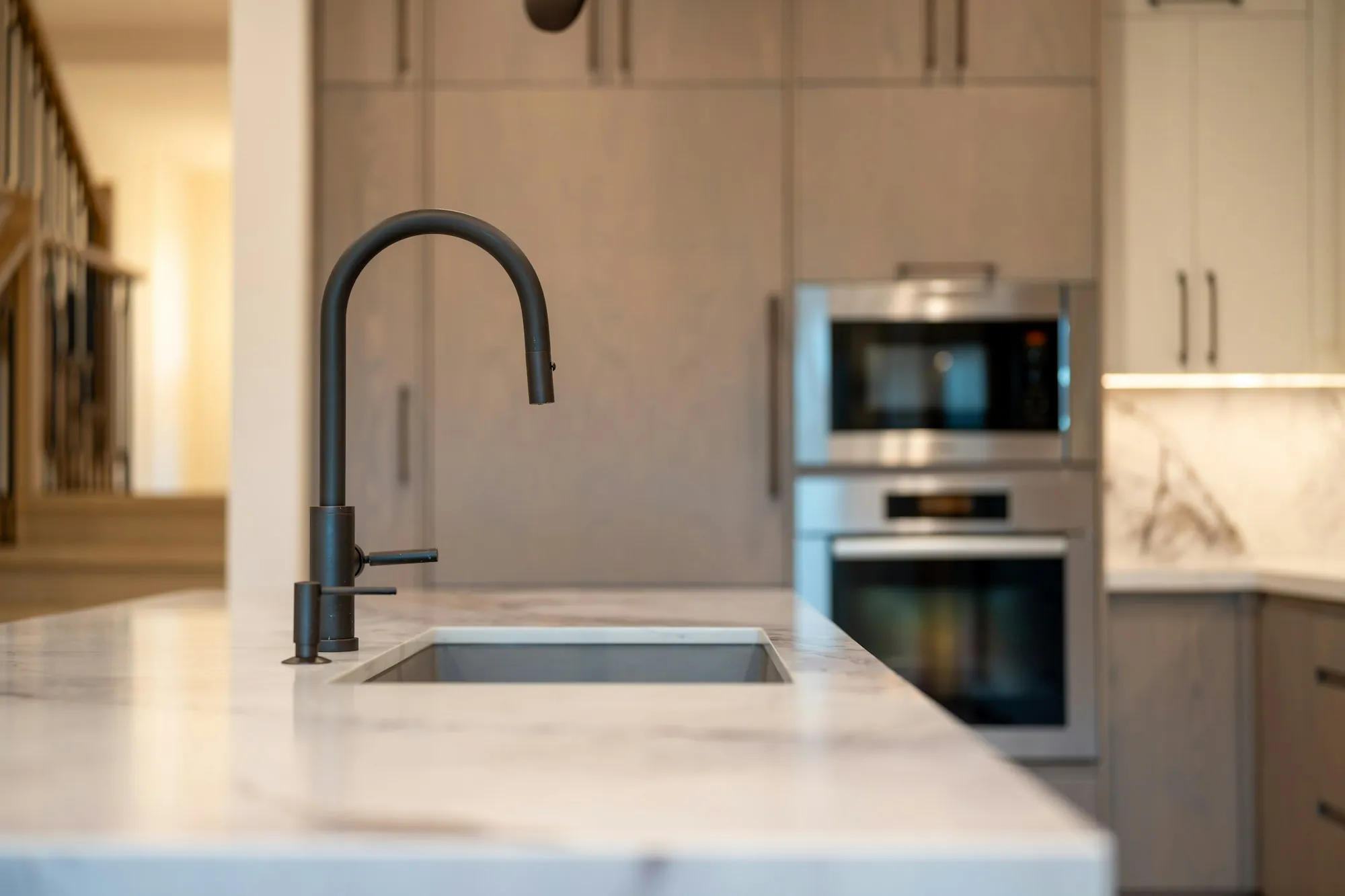 Bright modern kitchen with a black faucet and wood cabinets